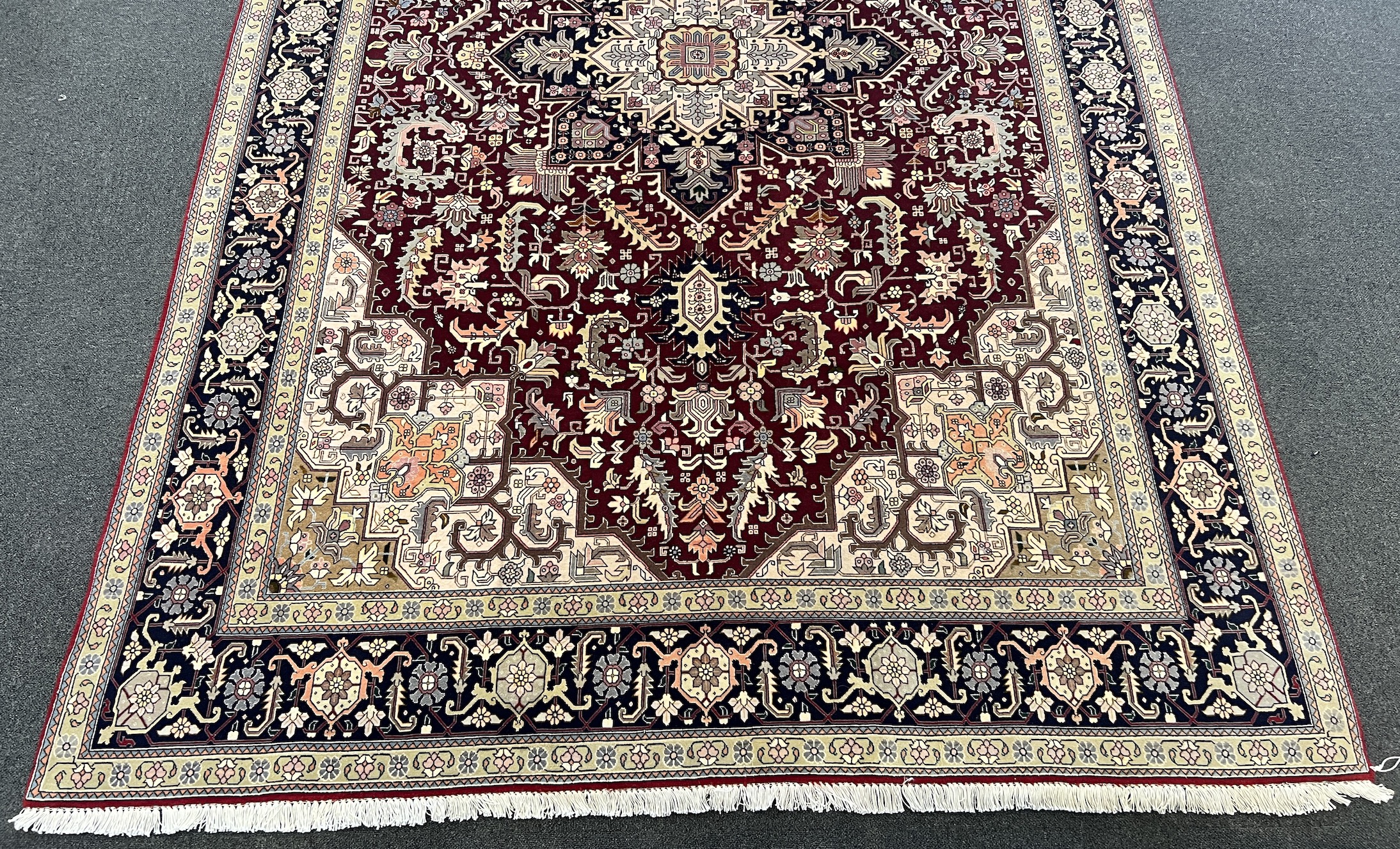 A Tabriz part silk burgundy ground carpet